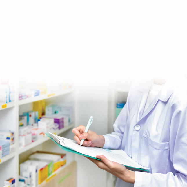 pharmacist in pharmacy checking off a list of prescriptions