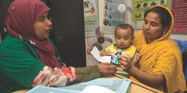 Bangladesh Emdadul Bitu woman taking medicines in pharmacy